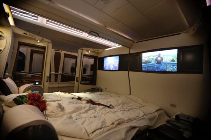 Two adjoining Singapore Airlines A380 Suites with the divider lowered and the beds made up as a double