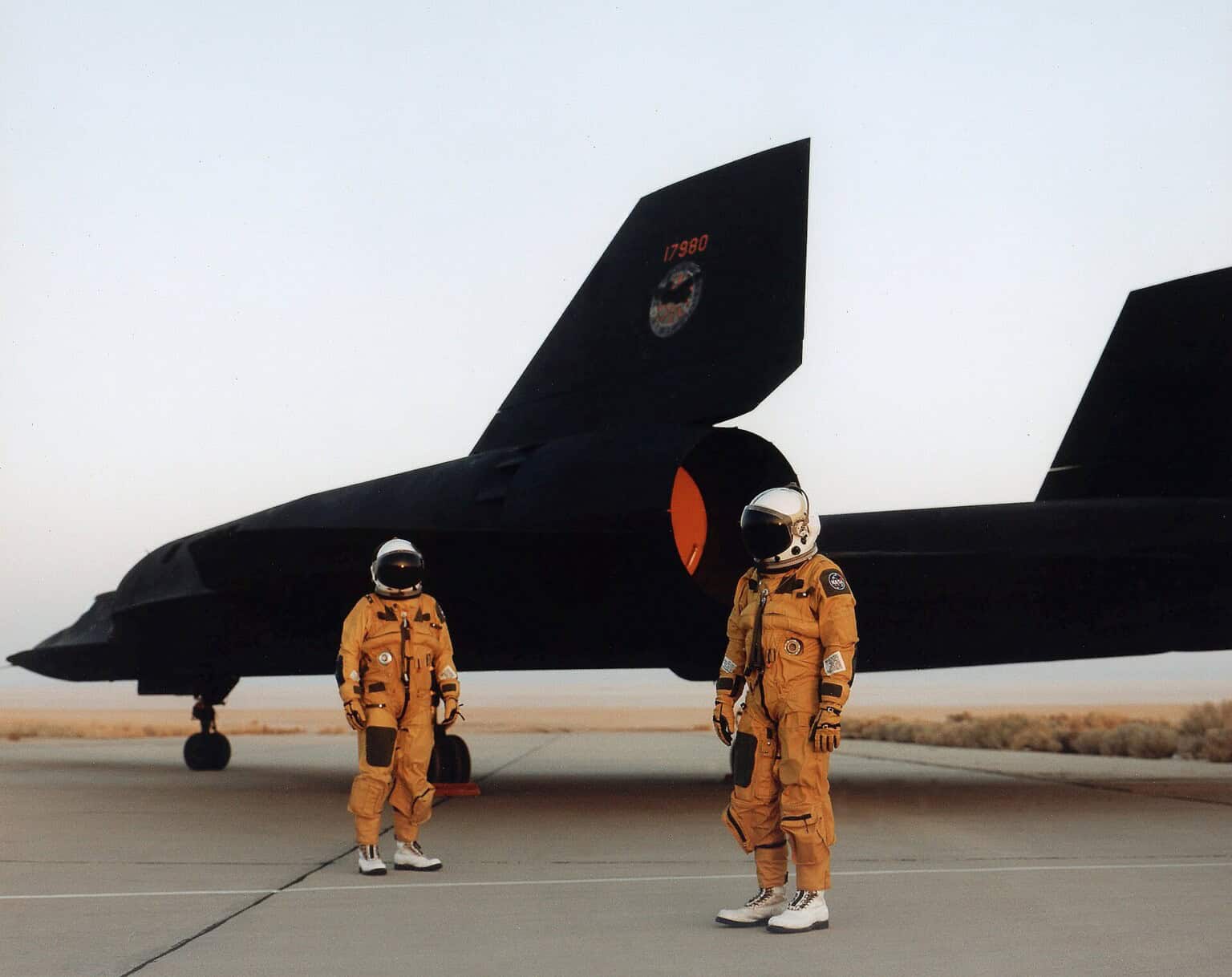 The crew of a NASA Lockheed SR 71 Blackbird standing by the aircraft in their pressurized flight suits, 1991