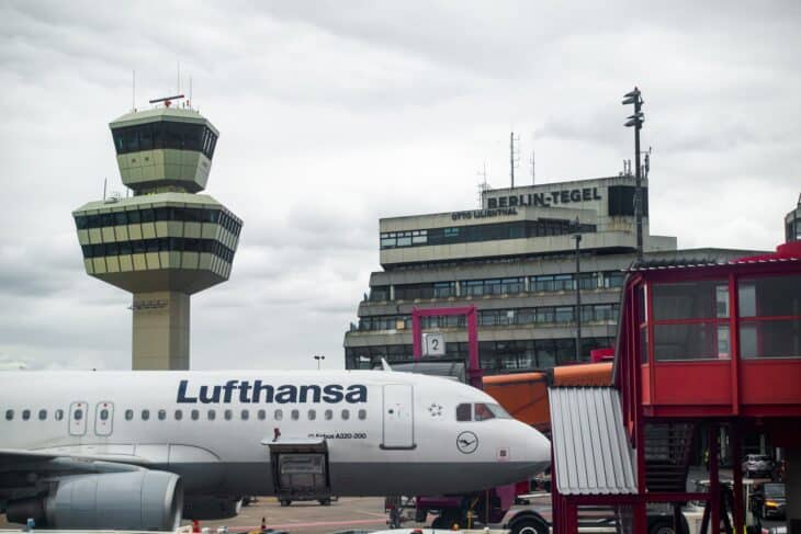 Berlin Tegel's control tower and hexagonal Terminal A with a Lufthansa Airbus at the gate