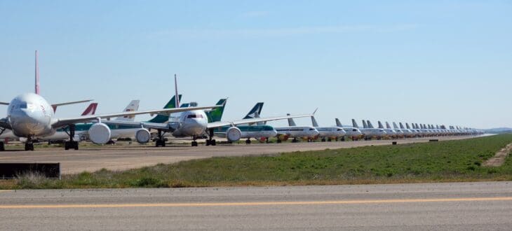 A long row of stored airliners parked beside the runway at Ciudad Real Central Airport