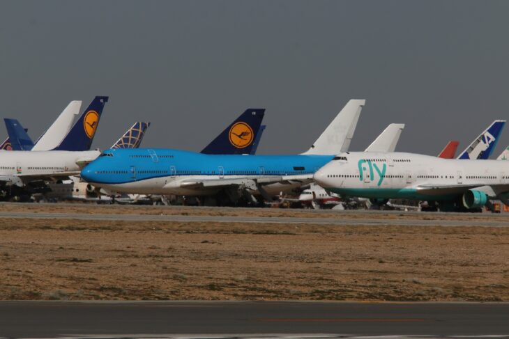 Retired widebody airliners, several with Lufthansa tails, parked in a row at the Mojave Air and Space Port