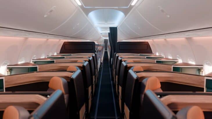 Rendering looking down the aisle of an Alaska Airlines 737-10 Aurora Suites cabin, with a single suite on each side of the aisle