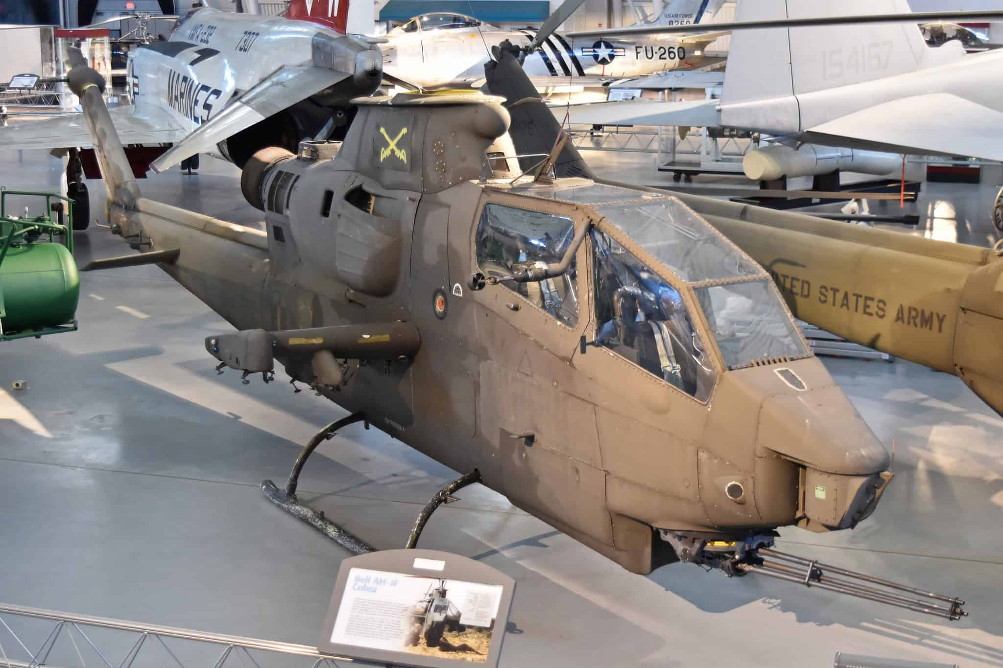Weathered AH-1 Cobra with stub wings and chin turret on display indoors at the Udvar-Hazy Center