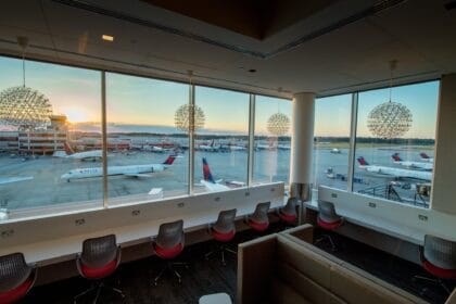Sunset over a ramp of Delta jets seen through the floor-to-ceiling windows of the Delta Sky Club in Atlanta's Concourse B