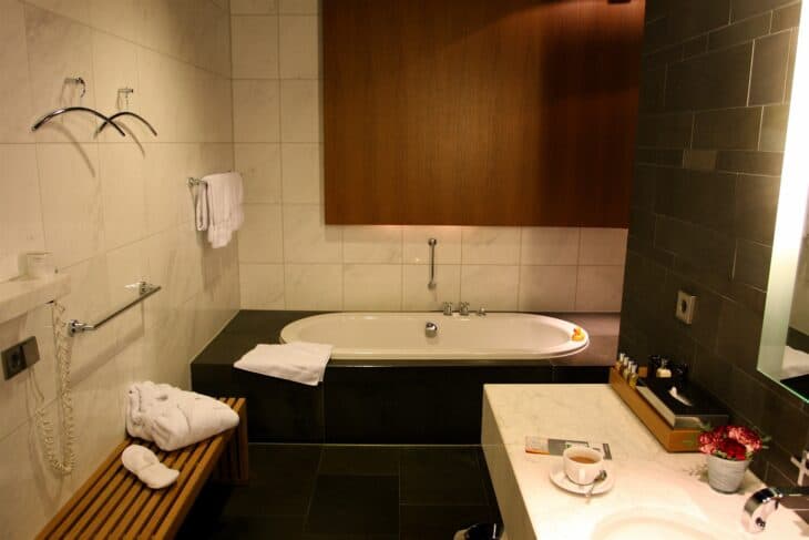 A full-size bathtub with bathrobe and towels in a bathroom at the Lufthansa First Class Terminal in Frankfurt