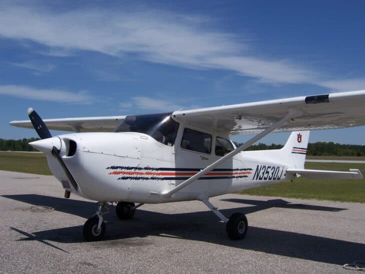 Auburn University Cessna 172 N3530J with orange and navy stripes parked on the ramp at Auburn University Regional Airport