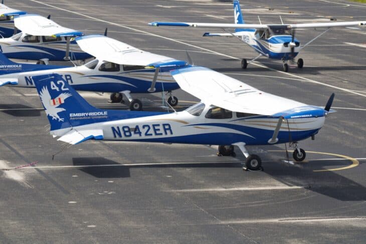 Embry-Riddle Cessna 172S N842ER in blue and white university livery on the Daytona Beach ramp, with more of the fleet behind it