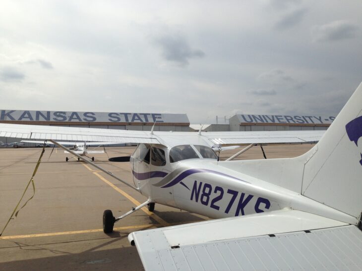 Kansas State University Cessna N827KS parked on the K-State Salina flight line, with the Kansas State University hangar behind it