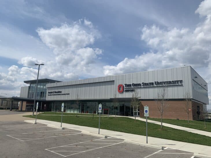 The Knowlton terminal building at Ohio State University Airport under a partly cloudy sky