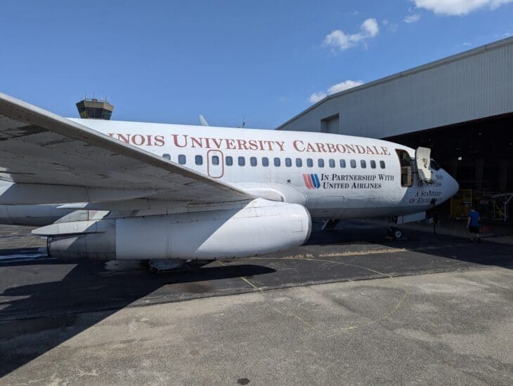 Former United Airlines Boeing 737-200 painted in Southern Illinois University Carbondale titles outside a hangar