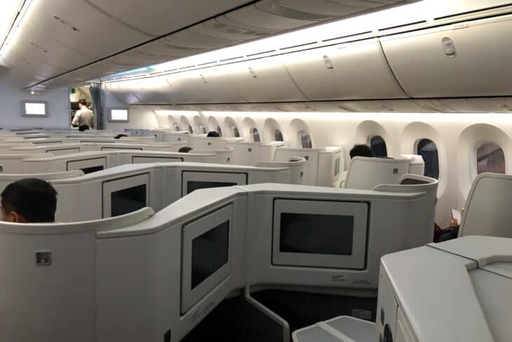 Hainan Airlines reverse herringbone business class seats with grey shells and seatback screens on a Boeing 787