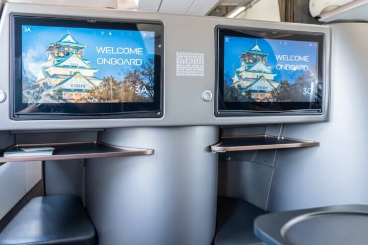 Two STARLUX Airlines business class seats, 3A and 3C, with welcome screens showing Osaka Castle