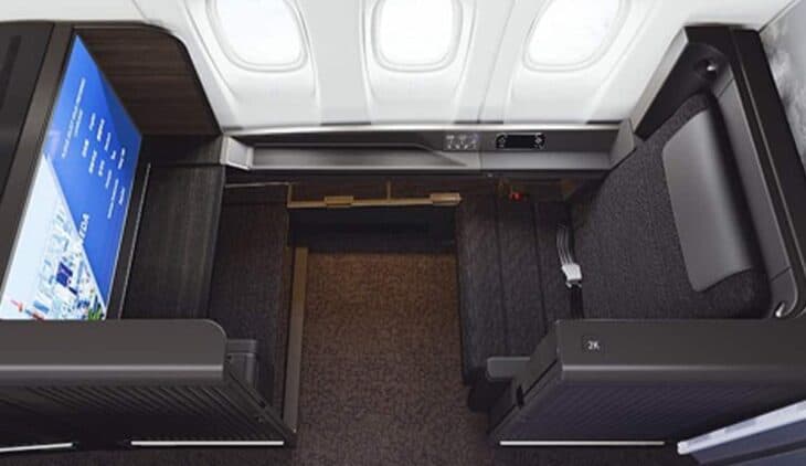 Overhead view of an ANA THE Suite first class seat on the Boeing 777-300ER, with its large screen, ottoman and suite walls