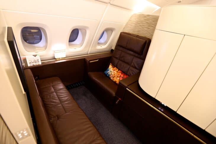 Etihad Airways A380 First Apartment with a leather armchair by the window and a separate sofa along the wall