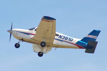 ATP Flight School Piper Archer N381D climbing out after takeoff against a blue sky