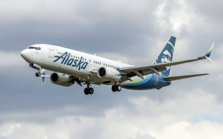 Alaska Airlines Boeing 737-800 N518AS landing with its gear down under a cloudy sky