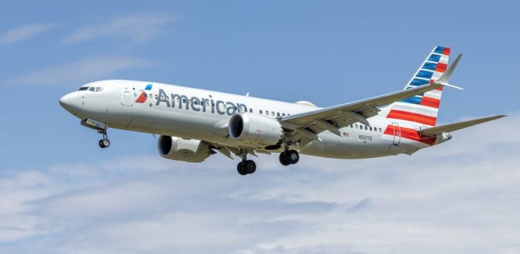 American Airlines Boeing 737-8 MAX N321TG on approach with its landing gear down, flag design on the tail