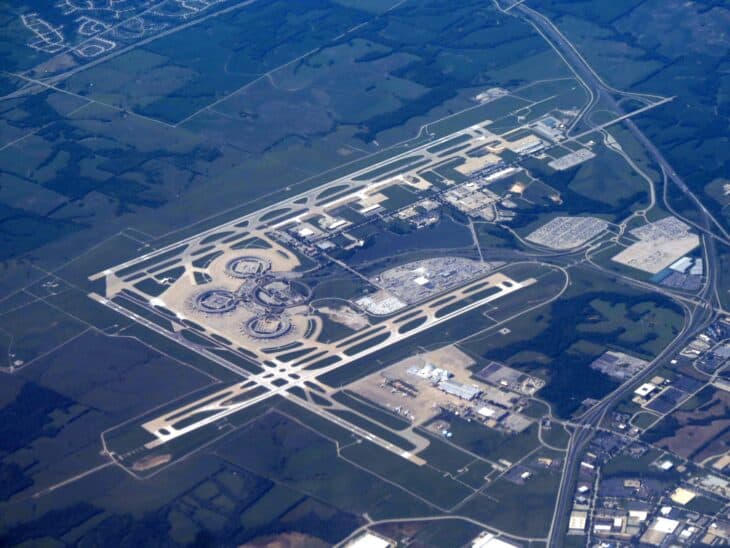 Aerial view of Kansas City International Airport, showing its crossing runways and the ring-shaped original terminals surrounded by farmland