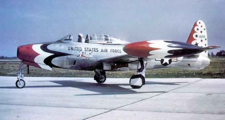 A silver Republic F-84G Thunderjet painted in early Thunderbirds markings parked on a ramp