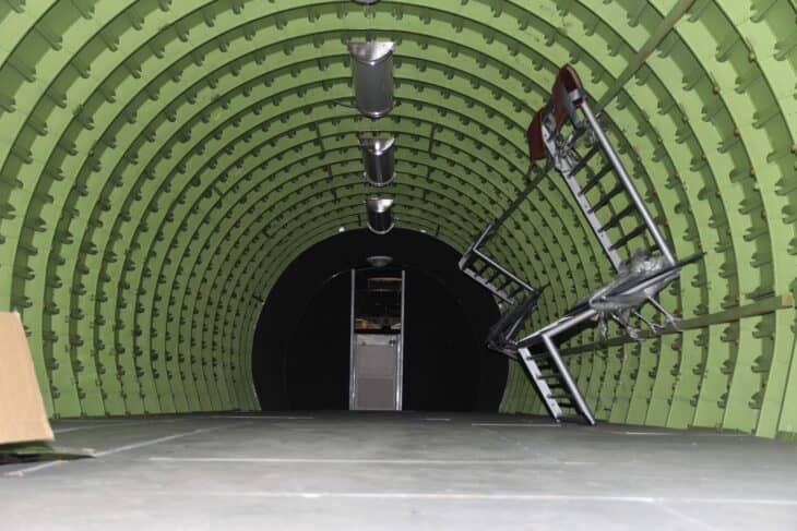 Interior of the Boeing 2707 SST mockup fuselage section stripped to its green-painted frames, looking forward toward the flight deck