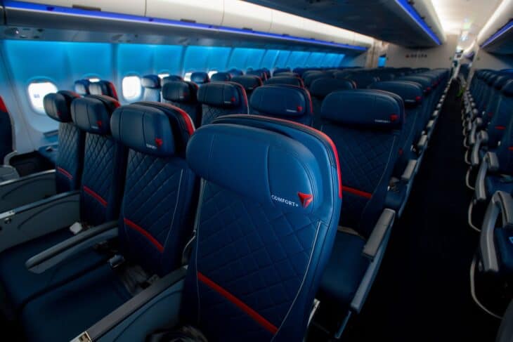 Delta Comfort+ seats with branded seatback covers on a Delta narrowbody