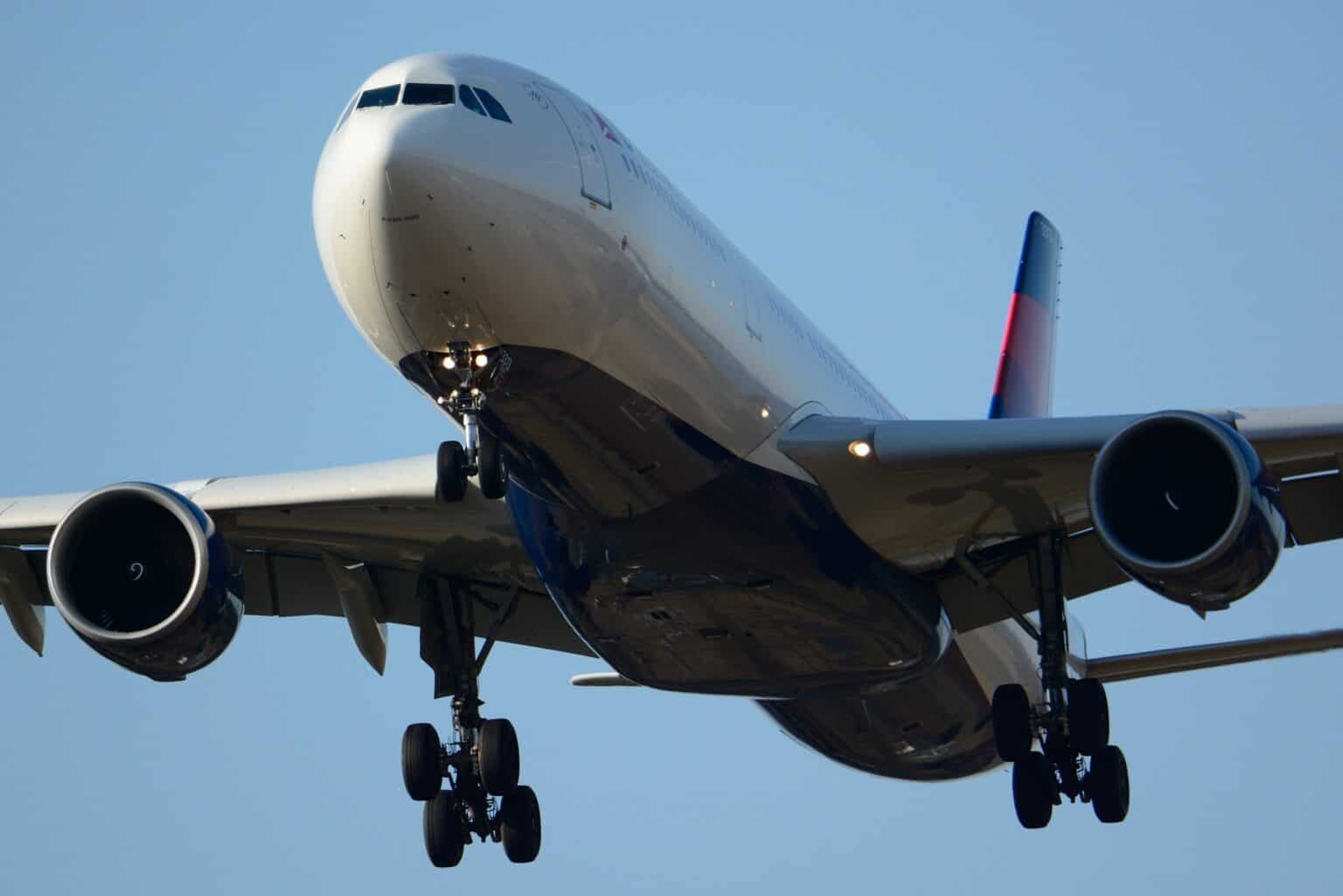 Delta Air Lines Airbus A330-300 N813NW seen head-on from below with its landing gear down, both Pratt & Whitney engines in view