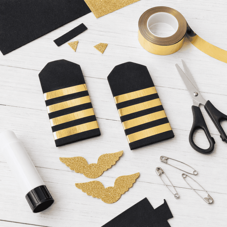 Black craft foam, gold tape and cardstock turn any white shirt into a pilot uniform.