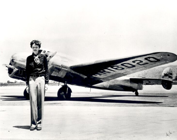 Amelia Earhart standing in front of her twin-engine Lockheed Electra 10E, registration NR16020