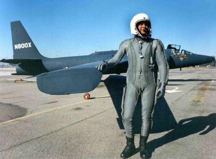 Francis Gary Powers in a high-altitude pressure suit and helmet standing beside a U-2