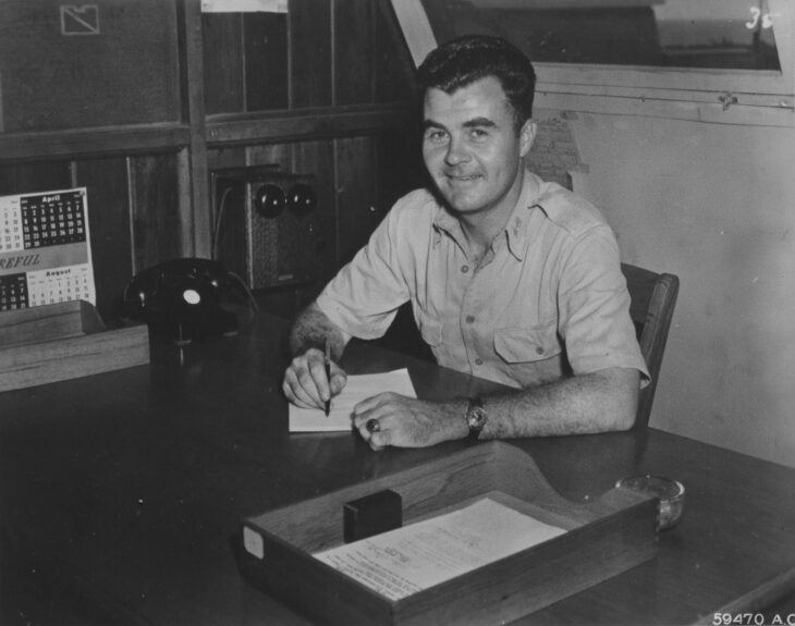 Colonel Paul Tibbets seated at a desk