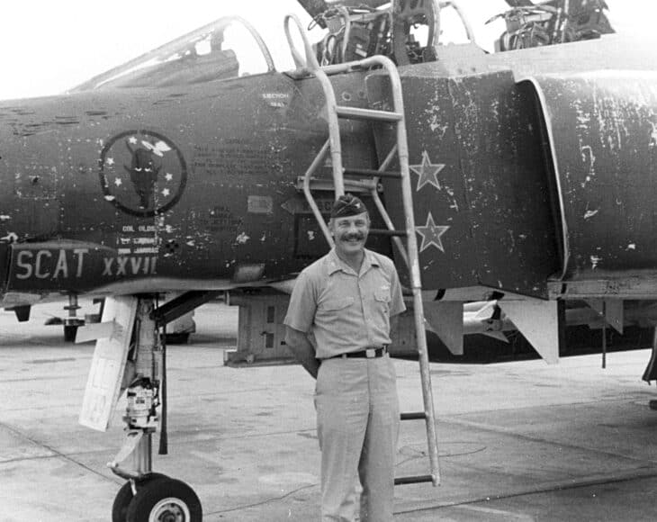 Robin Olds standing beside his F-4C Phantom II, Scat XXVII