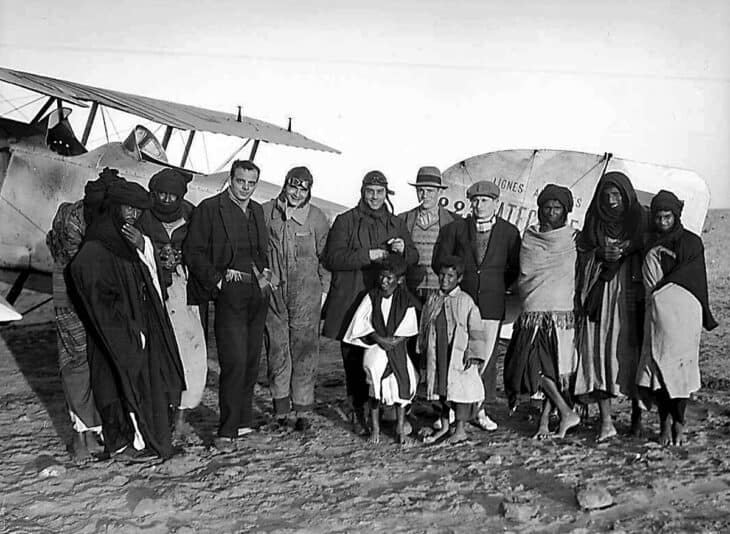 Antoine de Saint-Exupéry with a group of people in front of a Breguet 14 biplane