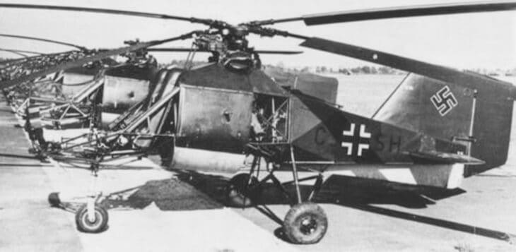 Flettner Fl 282 Kolibri helicopter in wartime German markings on an airfield, seen from the side with its two intermeshing rotors