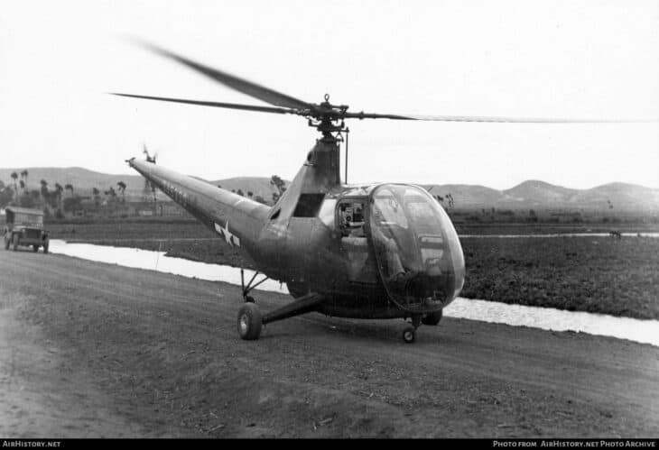 US Army Air Forces Sikorsky R-6A Hoverfly II 43-45330 parked on a dirt strip, rotor turning