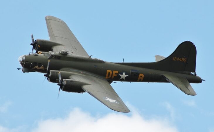 Boeing B-17G Sally B, G-BEDF, in flight against a blue sky, wearing olive drab paint and DF-A code letters