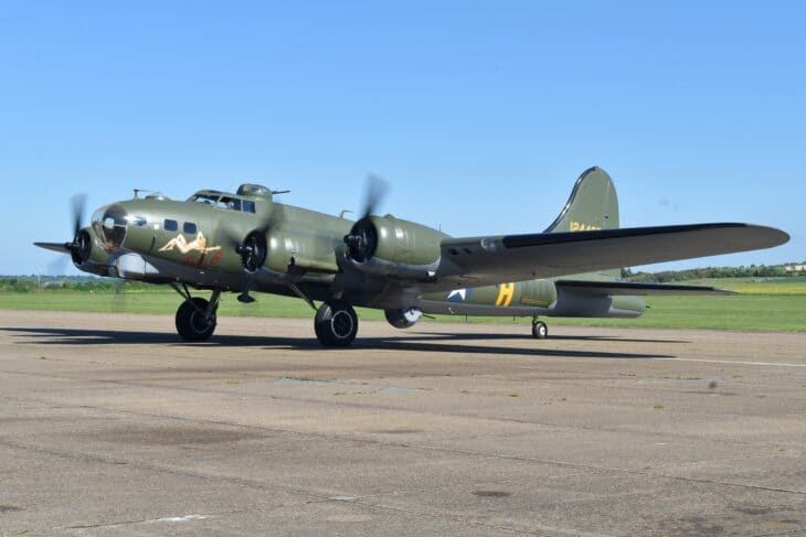 Boeing B-17G Sally B, G-BEDF, taxiing at Duxford in olive drab Memphis Belle markings with nose art and the tail serial 124485