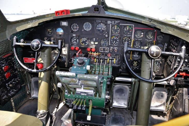 The flight deck of B-17G Sentimental Journey, N9323Z, with two control yokes, the instrument panel and the central throttle quadrant for its four engines