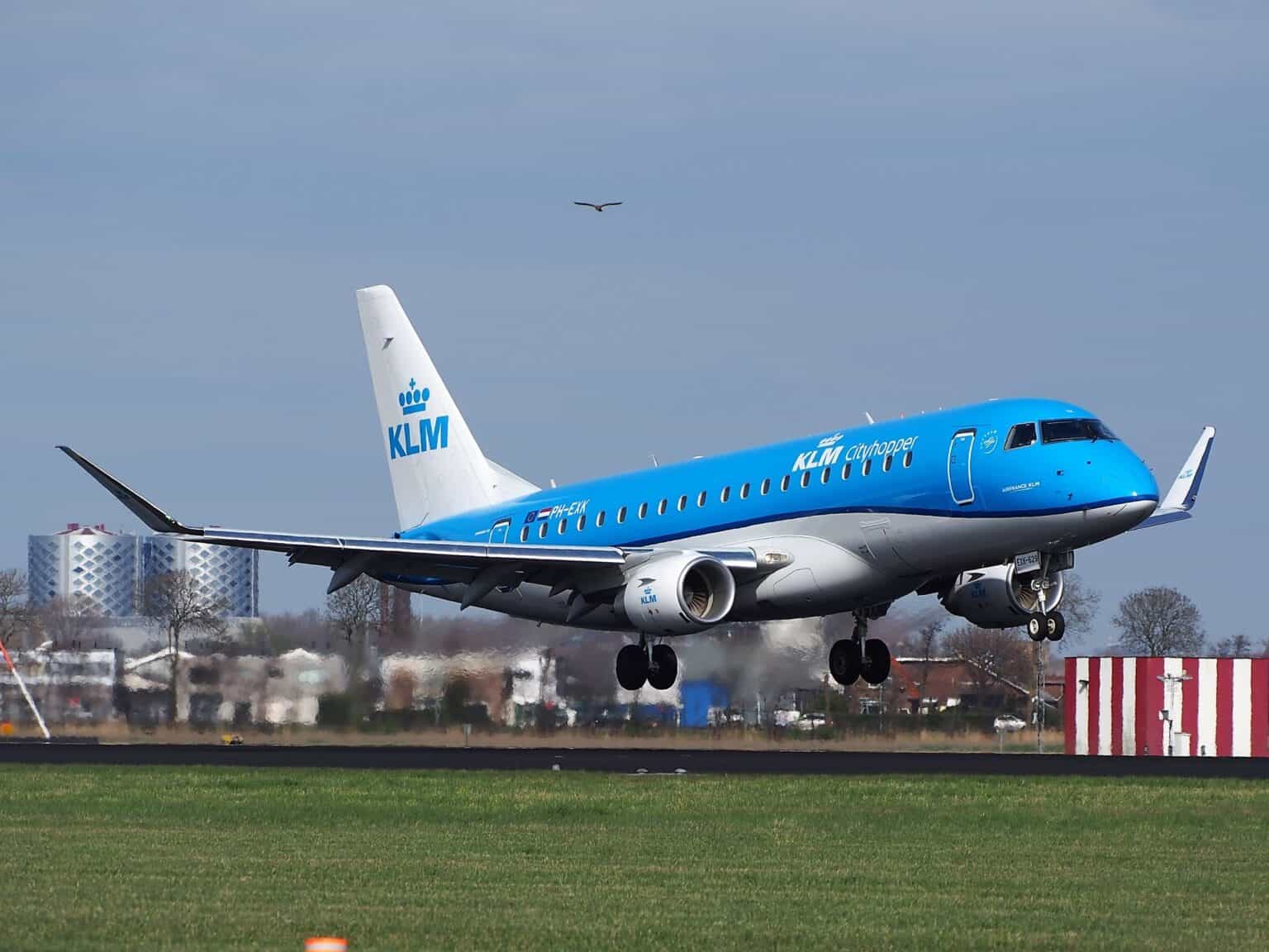 KLM Cityhopper Embraer 175 PH-EXK about to touch down at Amsterdam Schiphol under a dark sky