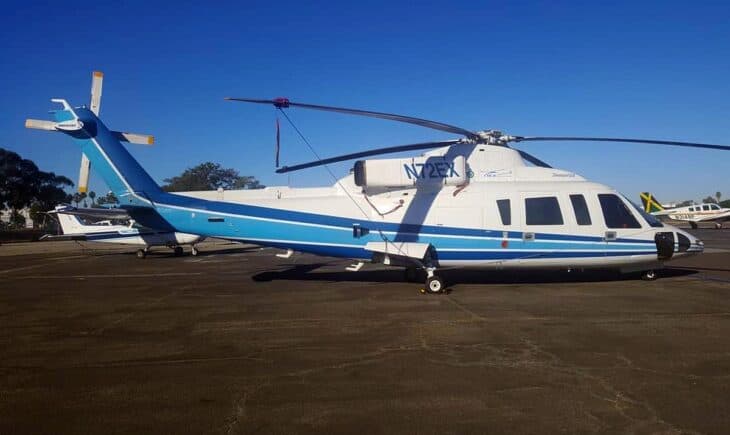 Sikorsky S-76B N72EX in white and blue parked on an airport ramp in 2018