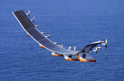 NASA's Helios Prototype solar-powered flying wing in flight over the Pacific, its long wing curved upward