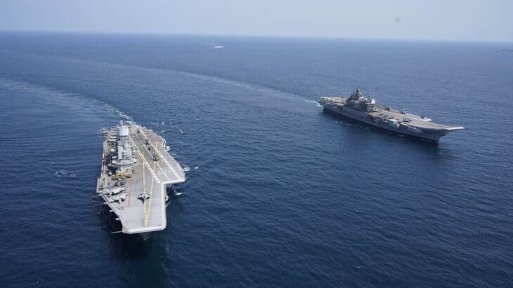 The Indian Navy aircraft carriers INS Vikrant and INS Vikramaditya sailing together with their escorts and carrier aircraft overhead