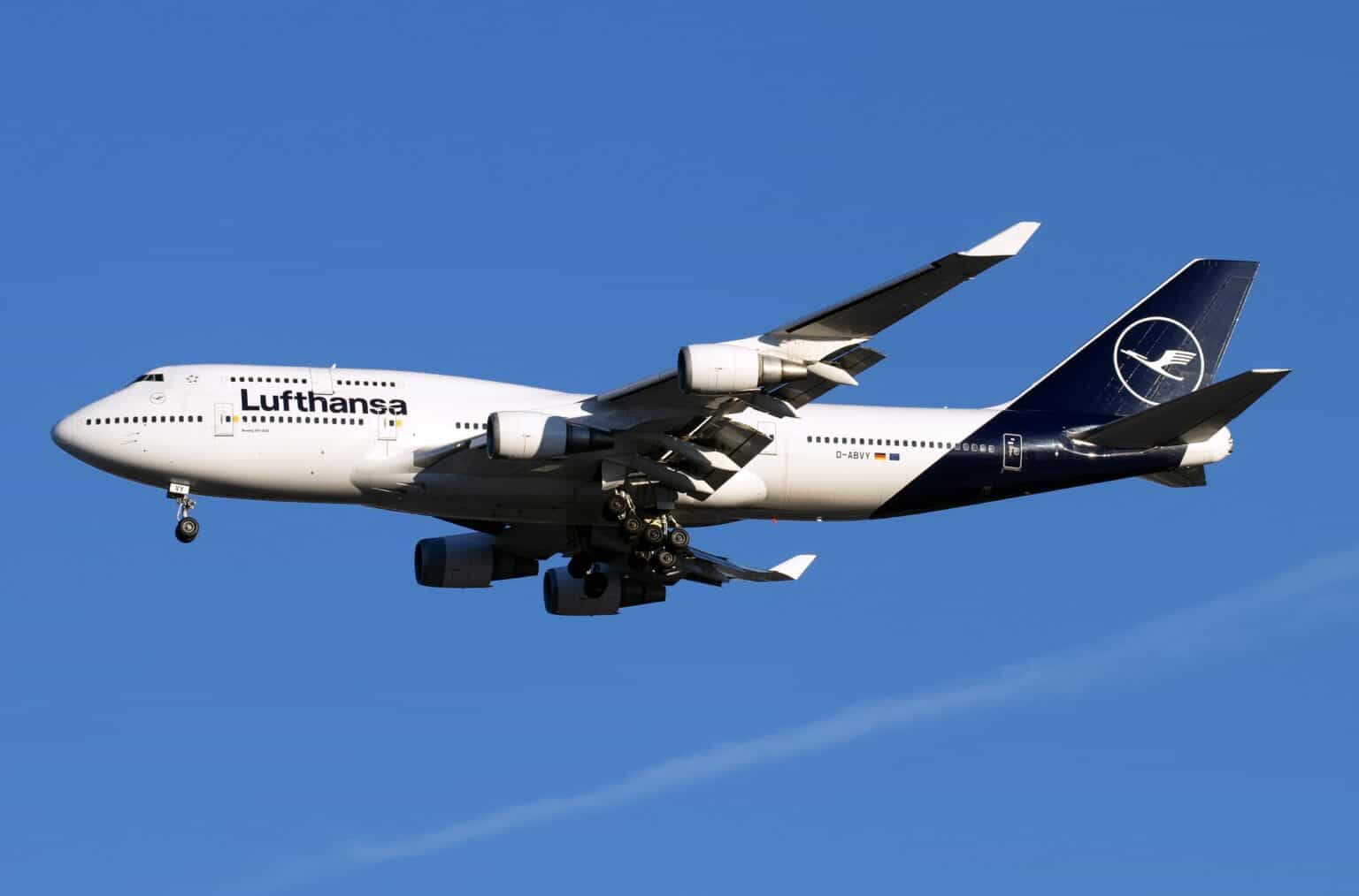 Lufthansa Boeing 747-400 D-ABVY on approach with landing gear down against a blue sky