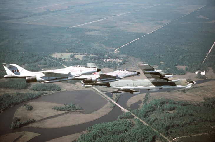 Two Canadian CF-101B Voodoos flying in close formation with a U.S. Air Force B-52G Stratofortress over Florida