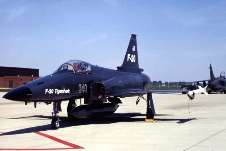 Northrop F-20 Tigershark in a dark blue aggressor paint scheme on the ramp, carrying a belly drop tank and the number 340 on its nose