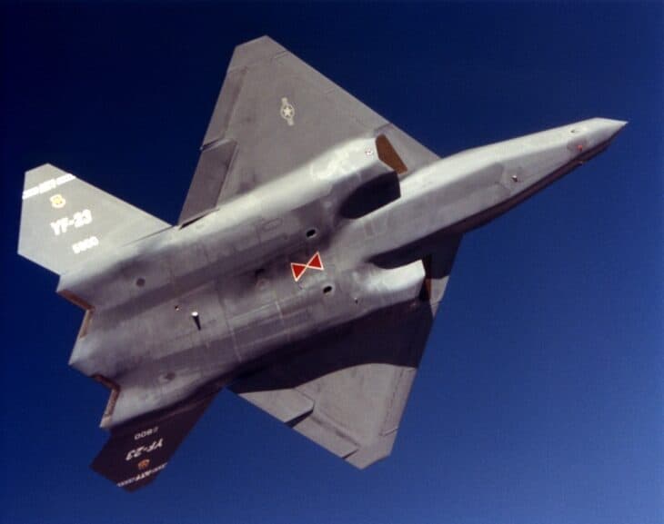 Underside of the YF-23 PAV-1 in flight, with a small red hourglass marking painted on the belly