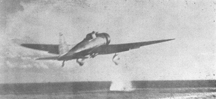 An Aichi D3A Val dive bomber with fixed spatted landing gear lifting off the deck of the carrier Akagi