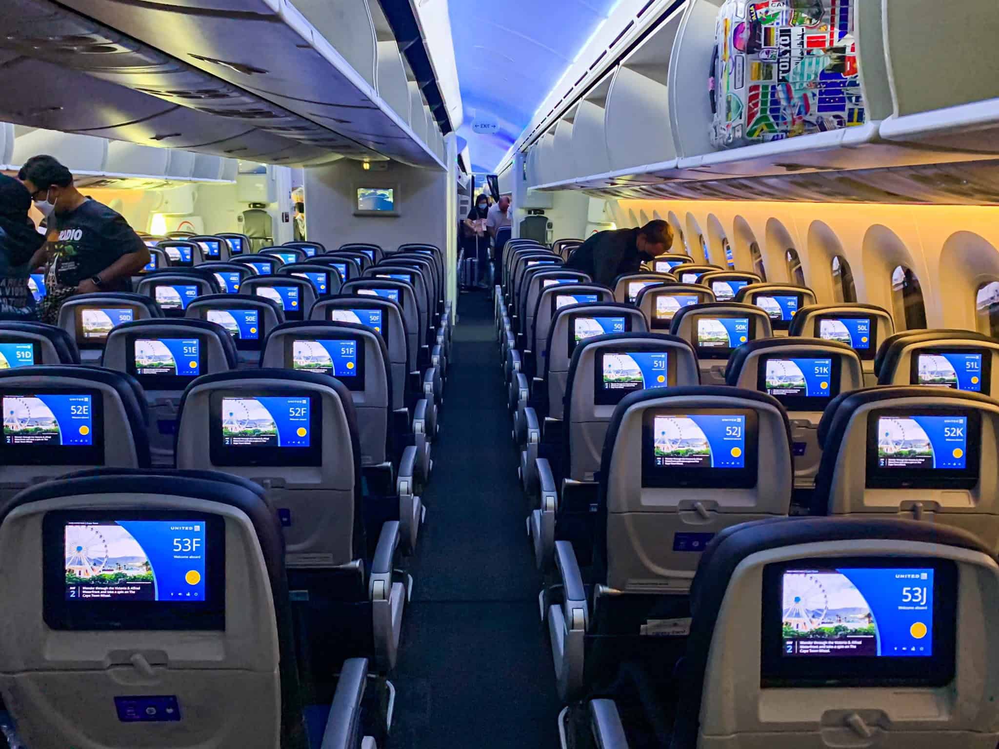 Economy cabin of a United Airlines Boeing 787-9 seen from the aisle, three seats on each side and three in the middle