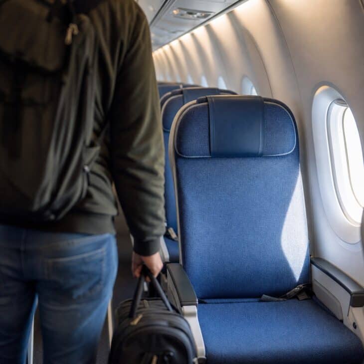 Revealing the actual seat shares the moment without exposing a document or booking detail.