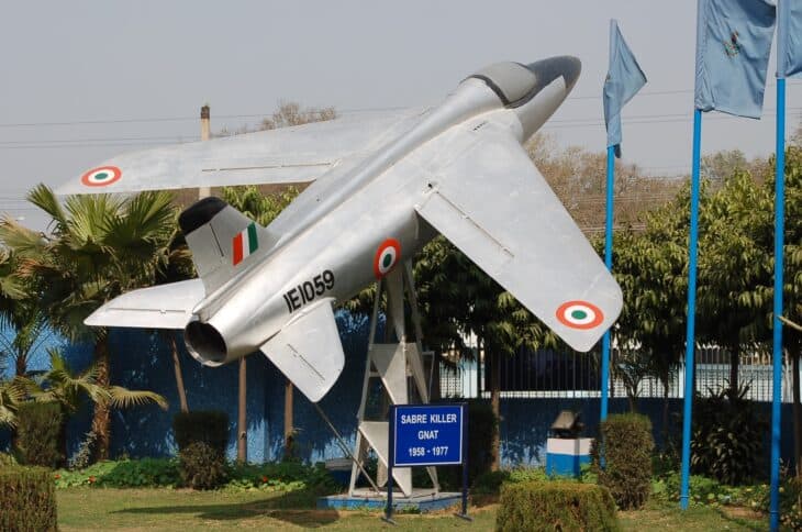 Indian Air Force Folland Gnat IE1059 displayed on a plinth beside a Sabre Killer sign