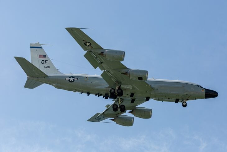 RC-135V/W Rivet Joint with Offutt OF tail code flying against a blue sky